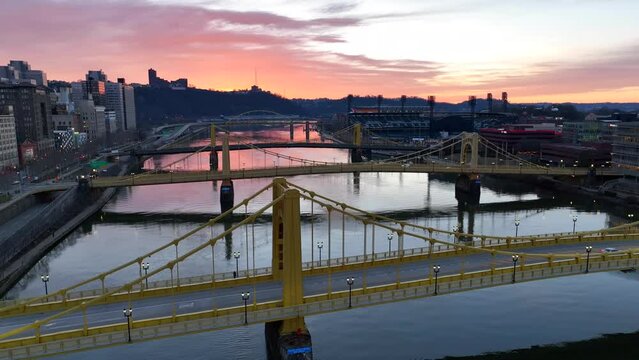 Sunset over three yellow bridges and PNC Park in Pittsburgh Pennsylvania. Roberto Clemente, Andy Warhol, and Rachel Carson bridges over Allegheny River.