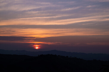 Fototapeta premium Natural backgrounds of the sunset view with the evening sky on the mountain in the winter of Nan province, The north of Thailand.
