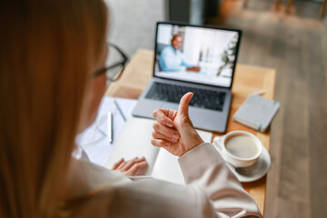 Close up of businesswoman via videoconference discuss project with colleague use sign language 