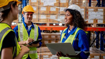 Industrial warehouse diversity engineer or worker man and woman meeting co-working talking together and checking stock goods and box shelf stock in the warehouse factory store. Warehouse Logistic conc