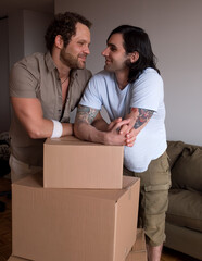 Happy gay couple moving in together