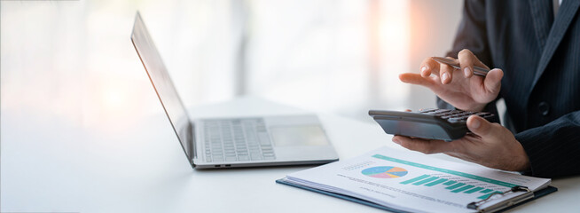 Asian businesswomen work using laptops and tablets, calculators to calculate make an account...