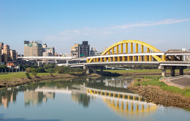 Yellow Rainbow Bridge overlooking the river downtown building city view of Taipei Taiwan