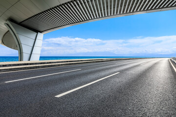 Asphalt road and bridge with lake scenery in Xinjiang, China.