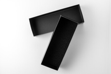 Packing in an open black gift box, black box on white background