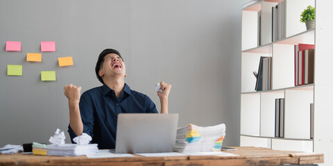 Mad crazy man employee sitting in office workplace with sticky notes all around, shouting furious...