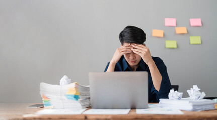 Mad crazy man employee sitting in office workplace with sticky notes all around, shouting furious angry, pissed off deadline and stressful job at office