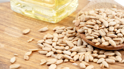 sunflower seeds and sunflower oil on a wooden background