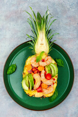 Obraz na płótnie Canvas Pineapple stuffed with prawn, rice and avocado.
