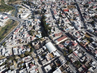 a drone photo aerial view of the city in puebla, mexico, hispanic downtown with the blue sky, clouds and travel 