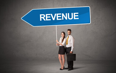 Young business person in casual holding road sign