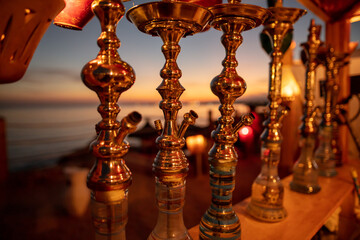 Hookahs in a cafe at sunset.