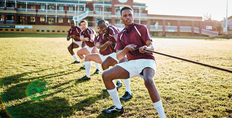 Man, team and sports tug of war with rope for fitness exercise, strength challenge or competition on field. Sport men in rivalry, teamwork struggle or leadership pulling ropes in training activity - obrazy, fototapety, plakaty