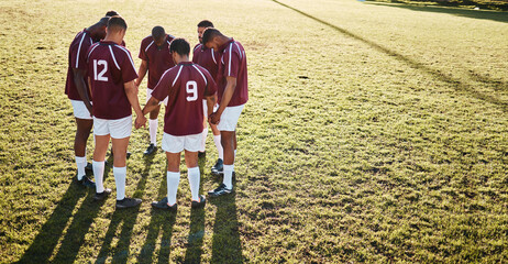 Men, huddle and team holding hands praying on grass field for sports coordination or collaboration...