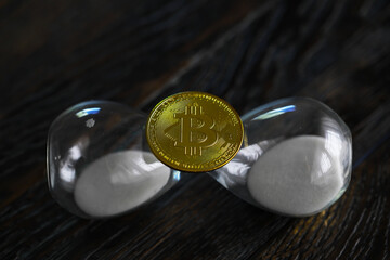 Bitcoin gold coin and defocused chart background. Virtual cryptocurrency concept.