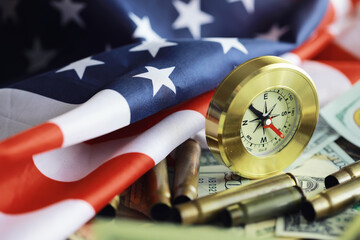 Money bill with golden Compass. Bullets and cartridge cases as a military concept. Close up US...
