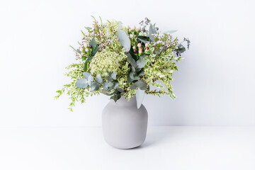 Beautiful flower arrangement of 
delicate white flowers, Eucalyptus leaves, Queen Anne's Lace, and...