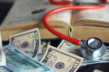 Financial analysis, auditing or business concept. Symbolic image of US Dollar banknotes with stethoscope.