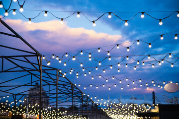 String of light bulb decorations and awning structures for outdoor activities, party, concert,...
