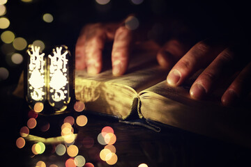 Ramadan Kareem background. Ornamental Arabic lantern glowing and the holy book of Quran.