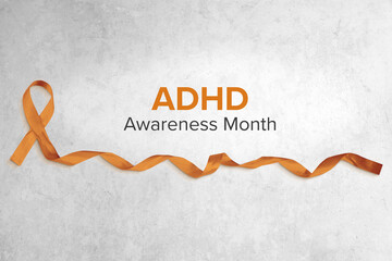 Orange Ribbon Curled on Concrete Background, ADHD Concept Banner