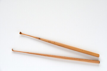 Handmade bamboo ear wax removers on white background.