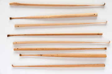 Handmade bamboo ear wax removers on white background.