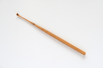 Handmade bamboo ear wax remover on white background.