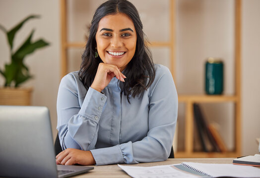 Happy, smile and portrait of Indian woman at desk for management, planning and business. Research, confidence and positive face of employee in office or professional startup company in India