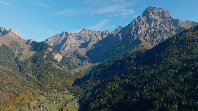 Les Plans-sur-Bex Village With The Majestic Grand Muveran Mountain Summit During Autumn In Vaud, Switzerland. Aerial Wide Shot