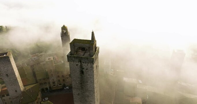 Misty Clouds Canopy Medieval Towers Of San Gimignano Village In Tuscany, Italy. Aerial Orbiting