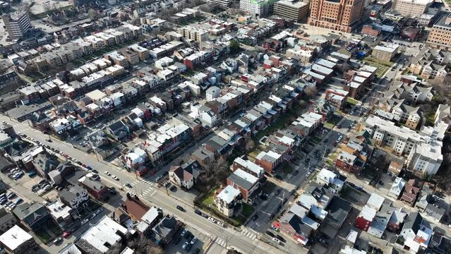 Sprawling Neighborhood Outside Of American City. High Aerial Drone Shot Orbit Of Row Houses In America.