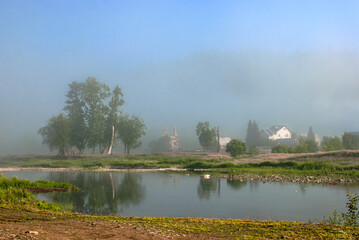 village by the river. rural houses on the coastline. panorama morning view of the village