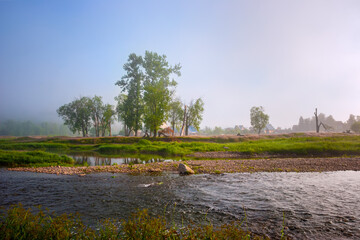 village by the river. rural houses on the coastline. panorama morning view of the village