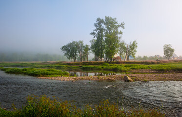 village by the river. rural houses on the coastline. panorama morning view of the village
