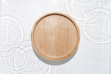 Wooden plate on the water surface background. Flat lay, copy space.	