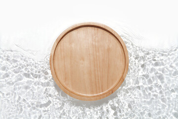 Wooden plate on the water surface background. Flat lay, copy space.	