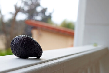An avocado on a white balcony of a house in the countryside