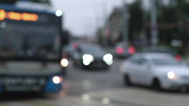 blurred busy street traffic interchange. unfocused cars rush along the highway of the city highway. the bus is moving fast through the city traffic. blurry evening trip home from work.