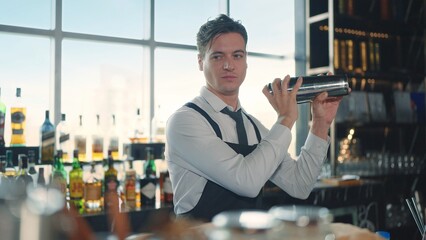 The profession bartender. Making a cocktail at bar in a restaurant. The bartender mixes the...