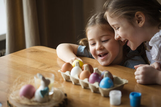 happy children paint eggs for easter at home