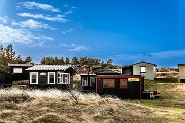 Tipperne nature reserve small fishing cottages and huts in a rural landscape at Rinkoebing fjord in Denmark
