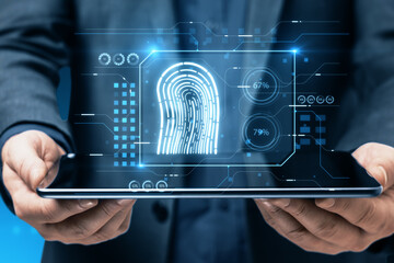 Close up of businessman hands holding tablet with creative finger print hologram on blurry background. fingerprint, biometrics, information technology and cyber security concept Double exposure.
