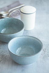 Table setting for dinner. Empty blue bowls for soup or breakfast on gray table.