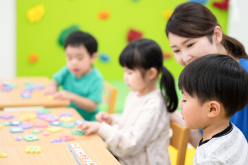 Obraz premium 保育所や託児所、幼稚園などで過ごす子どもたち 英語の勉強
