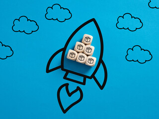 Wooden cubes with product box icons in a flying rocket symbol.