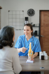 Portrait of a female doctor talking to an elderly patient about osteoarthritis.