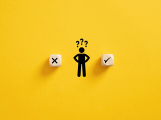 Fototapeta Decision making and choosing between the right and wrong. Confusion about to accept or to reject. Stickman with question mark standing in between the wooden cubes with check mark and x symbols. obraz