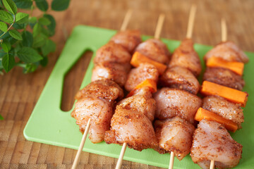 Fillet of chicken on skewers. Meat in marinade.
