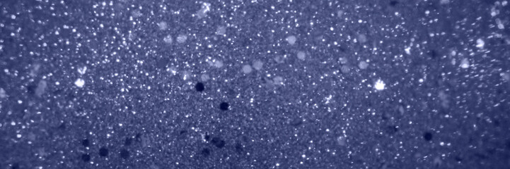 Abstract blurred violet background with shine diamond particles, magic glitter banner with copy space for festive design